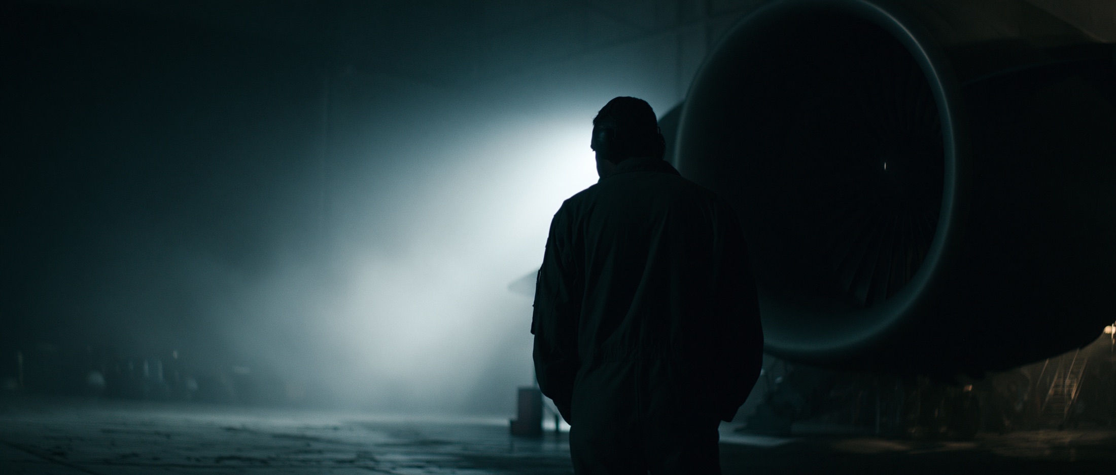 Lone technician dwarfed by an aircraft engine